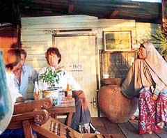 Stopping for a Green Spot and chat with the locals at a canal-side Thai Muslim house in Bangkok